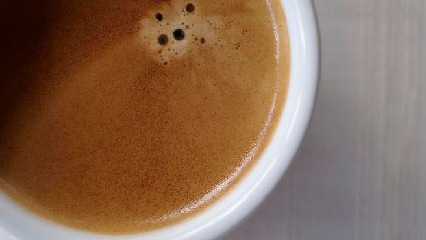 Close up Coffee froth on a hot coffee cup. Ready to drink hot cofffee