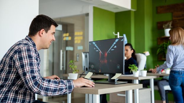 Man playing video games during working hours. Man hiding from his manager.