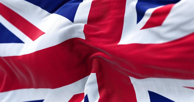 Close-up view of the United Kingdom flag waving in the wind. United Kingdom is a sovereign country that comprises England, Wales, Scotland, and Northern Ireland