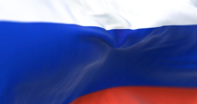 Close-up view of the Russian national flag waving in the wind. Russia is a transcontinental country spanning Eastern Europe and Northern Asia