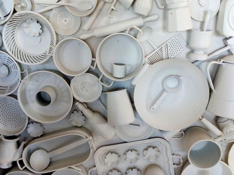 White painted kitchen utensils decorating the wall