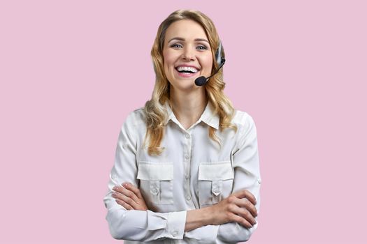 Portrait of happy smiling call center agent looking at camera. Call center operator with headset on color background.