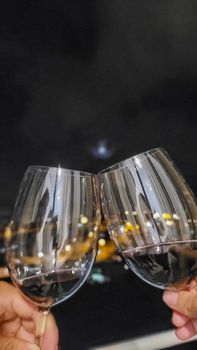 image of couple making a toast with glasses of wine in an apartment in Brazil