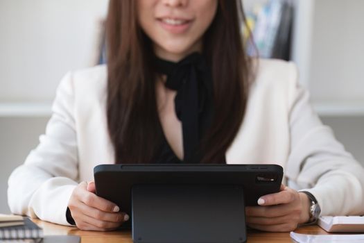 Portrait of a business woman using a tablet computer for data analysis, marketing, accounting.