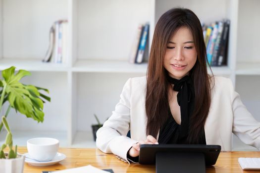 Portrait of a business woman using a tablet computer for data analysis, marketing, accounting.
