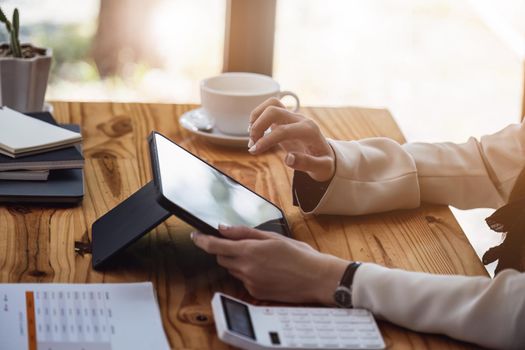 Portrait of a business woman using a tablet computer for data analysis, marketing, accounting.