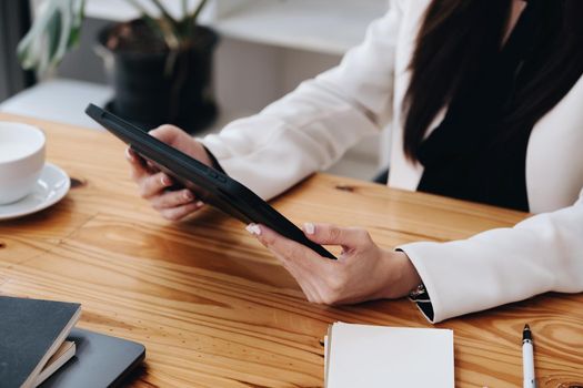 Portrait of a business woman using a tablet computer for data analysis, marketing, accounting.