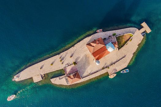 Picturesque island st. George and temple Gospa od Skrpela. Drone view. Boka Kotor Bay, Perast, Montenegro. Ancient Church Crkva Gospa od Skrpjela. Amazing mountain landscape. Beautiful gulf Kotor.