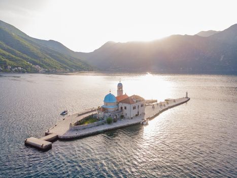 Picturesque island st. George and temple Gospa od Skrpela. Drone view. Boka Kotor Bay, Perast, Montenegro. Ancient Church Crkva Gospa od Skrpjela. Amazing mountain landscape. Beautiful gulf Kotor.