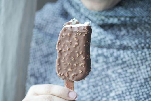 young women eating chocolate flavor ice cream .