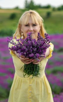 Beautiful woman in lavender field. Selective focus. Nature.