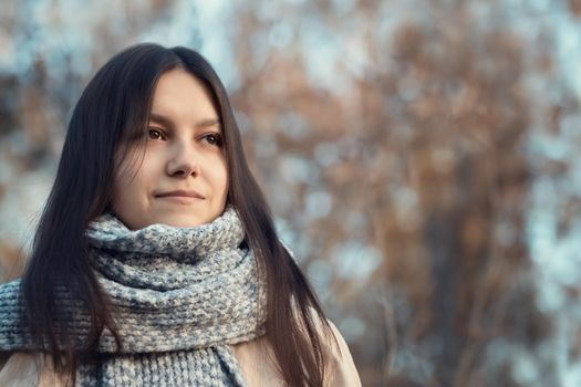 Girl enjoys fresh autumn air while walking in the park.