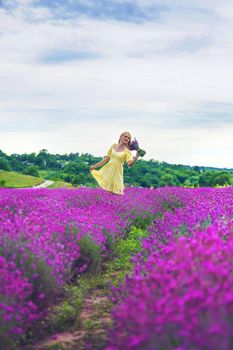 Beautiful woman in lavender field. Selective focus. Nature.