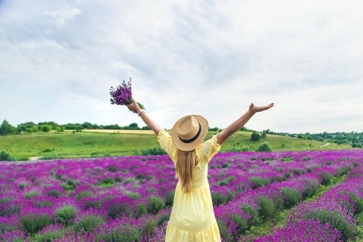 Beautiful woman in lavender field. Selective focus. Nature.