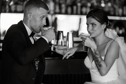 bride and groom inside a cocktail bar in a vibrant atmosphere