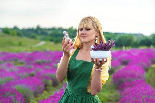 A woman collects lavender for essential oil. Selective focus. Nature.