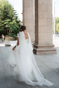 young woman bride in white dress in urban atmosphere