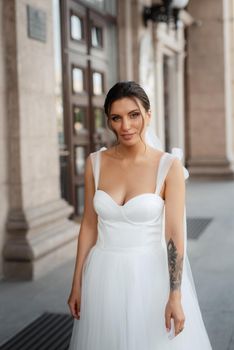 young woman bride in white dress in urban atmosphere