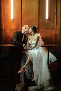 bride and groom inside a cocktail bar in a vibrant atmosphere