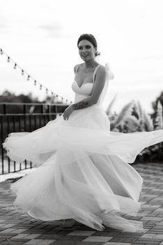 bride against the background of a yellow sunset on a pier near the river