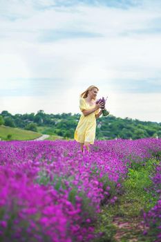 Beautiful woman in lavender field. Selective focus. Nature.