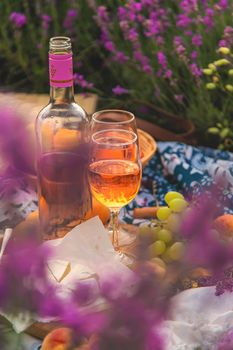 Wine in a lavender field. Selective focus. Food.