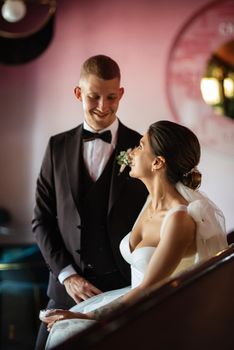 bride and groom inside a cocktail bar in a vibrant atmosphere