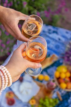 A woman and a man drink wine in a lavender field. Selective focus. Food.