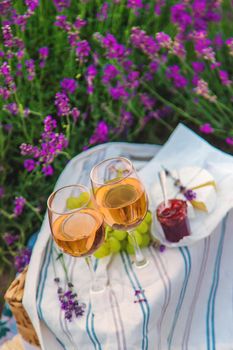 Wine in a lavender field. Selective focus. Food.