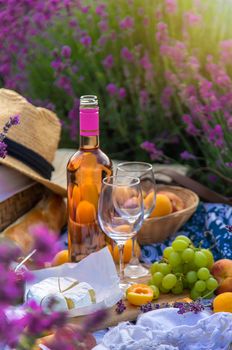 Wine in a lavender field. Selective focus. Food.