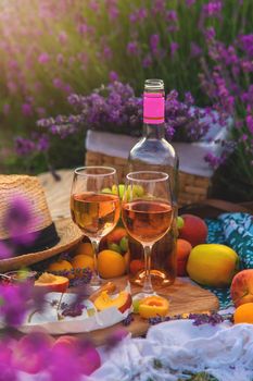 Wine in a lavender field. Selective focus. Food.