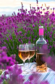 Wine in a lavender field. Selective focus. Food.