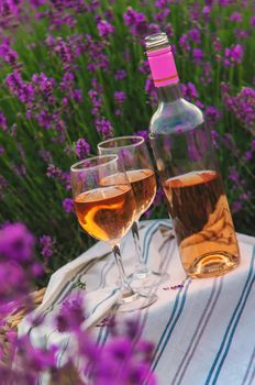 Wine in a lavender field. Selective focus. Food.