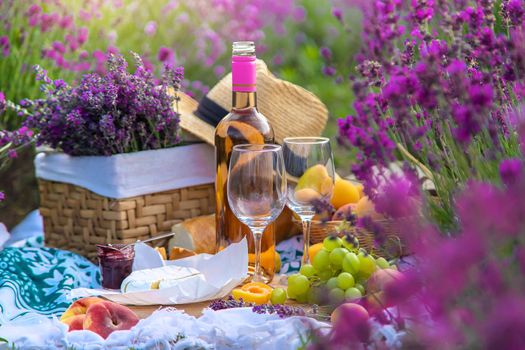 Wine in a lavender field. Selective focus. Food.