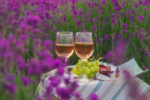 Wine in a lavender field. Selective focus. Food.