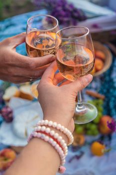 A woman and a man drink wine in a lavender field. Selective focus. Food.