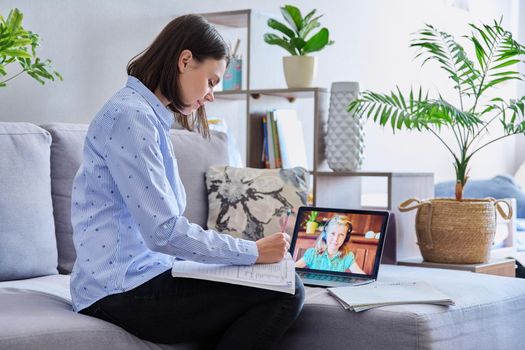 Young female teacher making video conference for child girl sitting in home office. Online meeting of student and teacher, e-learning, remote distance lesson. School, technology, teaching, knowledge