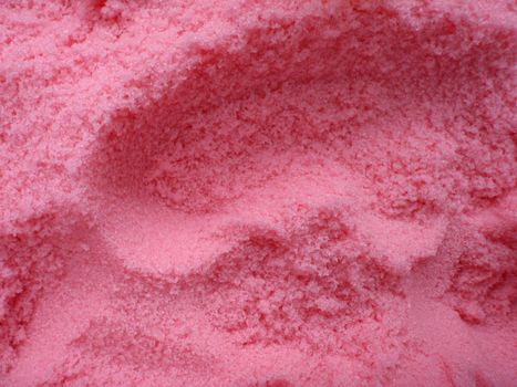 large amount of bright pink bath salt with scoop holes in it. Good pattern.