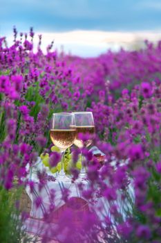 Wine in a lavender field. Selective focus. Food.