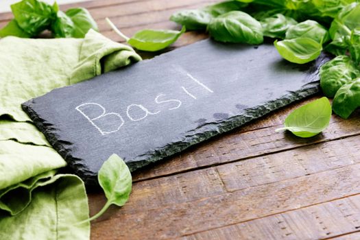 Fresh basil and a chalkboard sign with Basil written on it