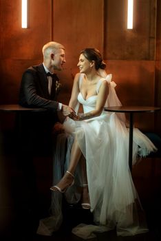 bride and groom inside a cocktail bar in a vibrant atmosphere