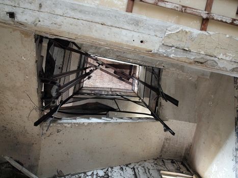 Looking up at a falling apart staircase of a Military building on Angel Island in San Francisco Bay.