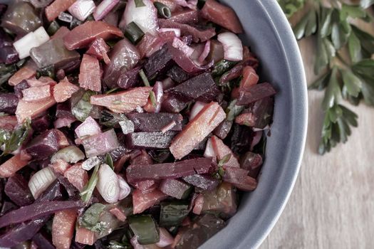 Vinaigrette with beetroot and boiled vegetables, traditional Russian homemade salad. Healthy food with vegetables for vegetarian dietary nutrition. View from above.