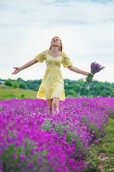 Beautiful woman in lavender field. Selective focus. Nature.