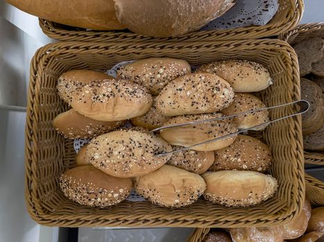 Delicious buns are on the table in a wicker basket. Top view, close-up.