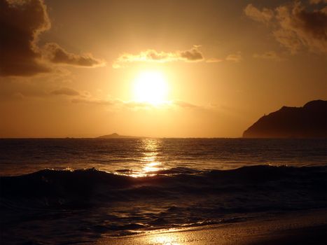 Sunrises over Rock Island by Maka'pua Point on Oahu, Hawaii.