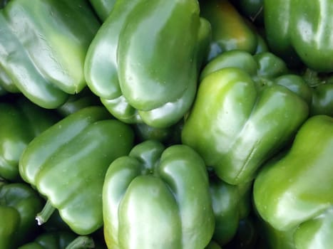 Pile of Fresh Green peppers for sale at Farmers Market in Oahu, Hawaii.