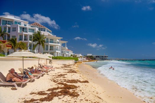 Hotel on a sandy beach on a sunny day in Playa del Carmen, Mexico.