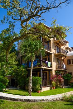 Beautiful yellow villa hotel among the trees in Playa del Carmen, Mexico.
