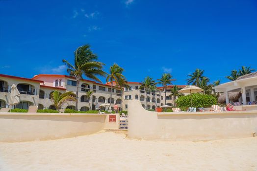 Hotel on a sandy beach on a sunny day in Playa del Carmen, Mexico.